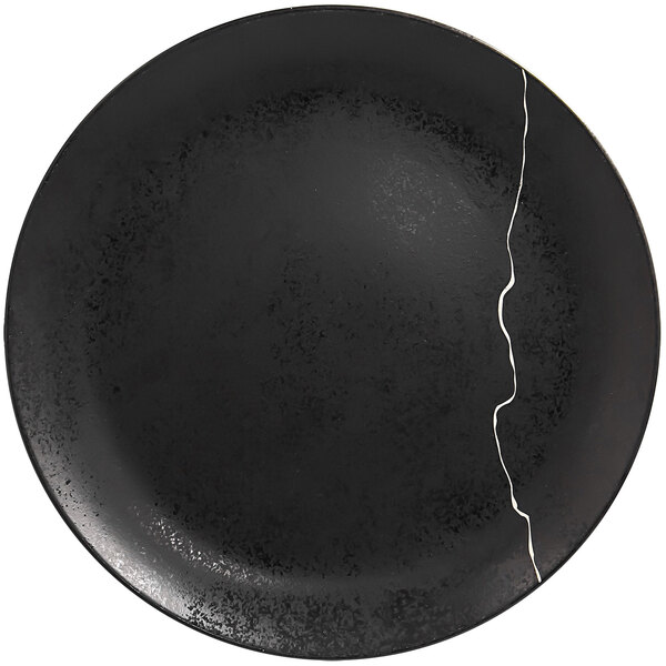 A black RAK Porcelain Kintzoo porcelain plate with silver detail and a crack in the middle.