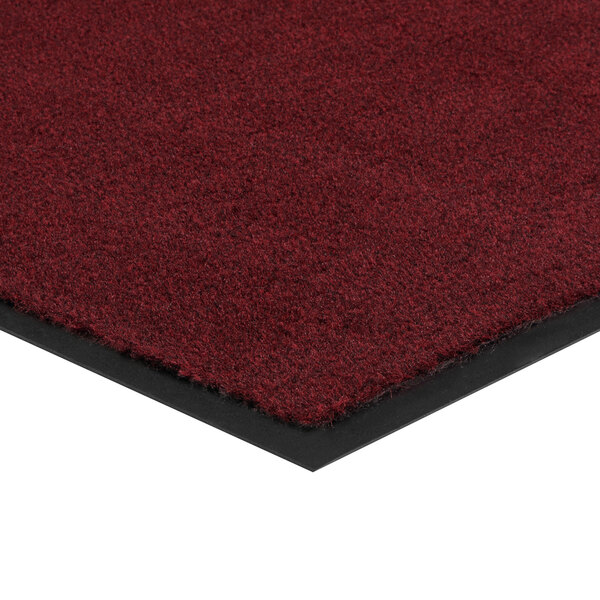 A close up of a Lavex crimson olefin entrance mat with black borders.