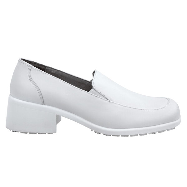 A white loafer shoe with a block heel.