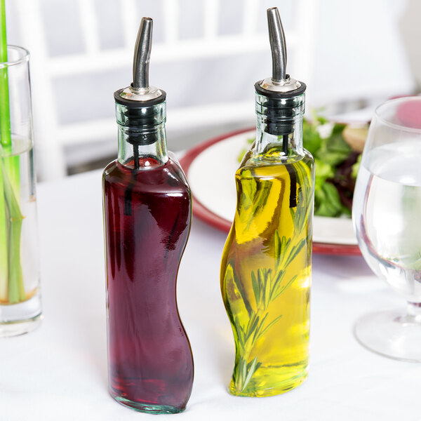 Two Tablecraft olive oil bottles on a table.
