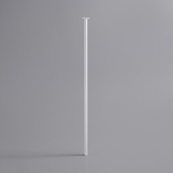 A white pole with a metal base on a gray surface.