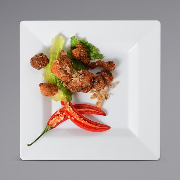 A Fineline Settings white square salad plate with chicken and vegetables on it.