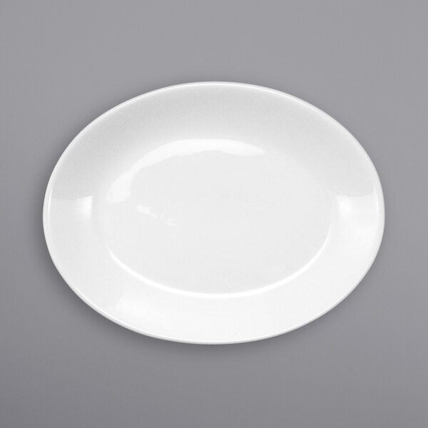 An International Tableware Torino white porcelain platter with a white rim on a gray surface.