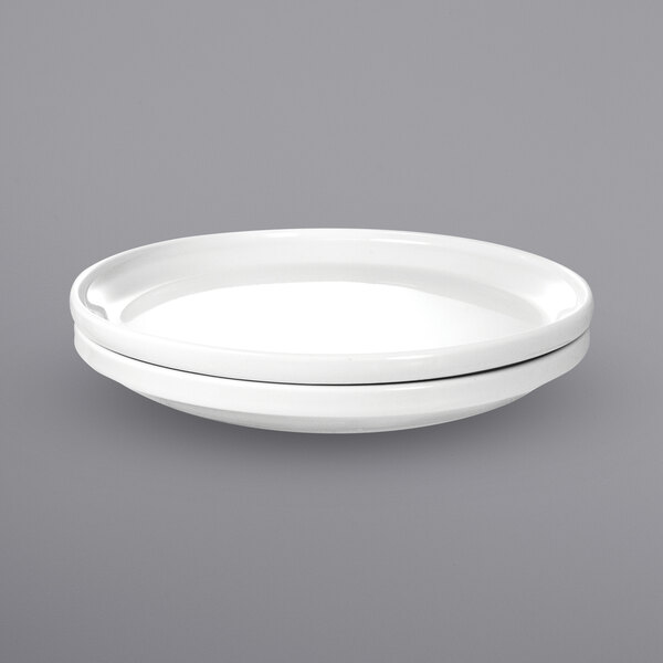 A stackable white porcelain plate with a black rim.