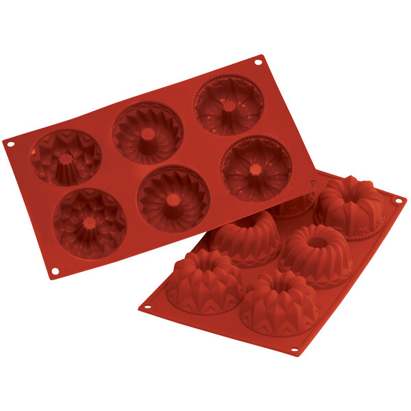 A close up of a red Silikomart fluted silicone baking mold with 6 compartments.