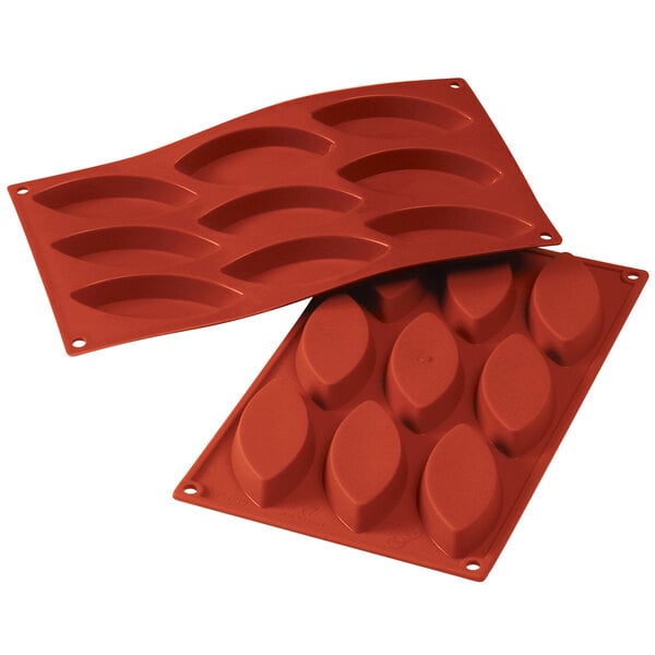 A red Silikomart silicone mold with oval shaped holes.