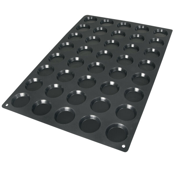 A black Silikomart silicone baking mold with 40 square cavities.