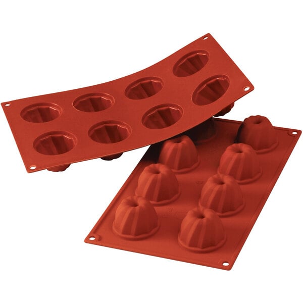 A red Silikomart silicone baking mold with eight small round cavities.