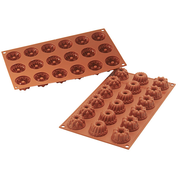 A brown Silikomart silicone baking mold with fluted cavities.