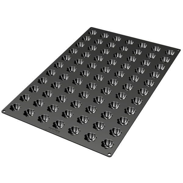 A black Silikomart baking tray with small holes in it.
