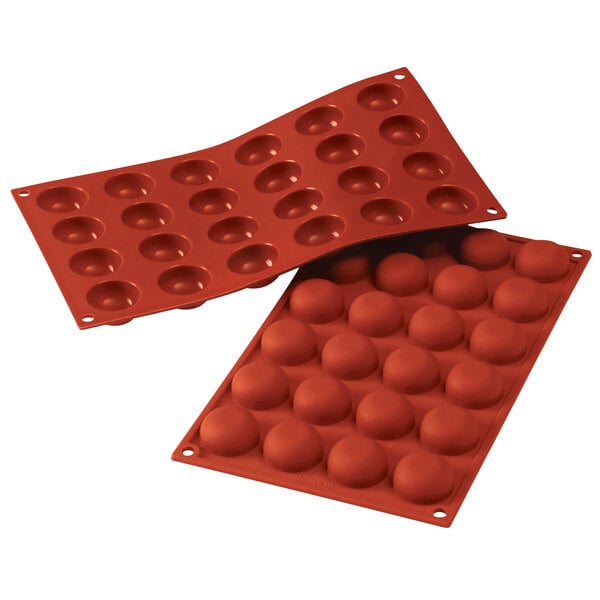 Two red Silikomart silicone baking molds with 24 pomponnette cavities.