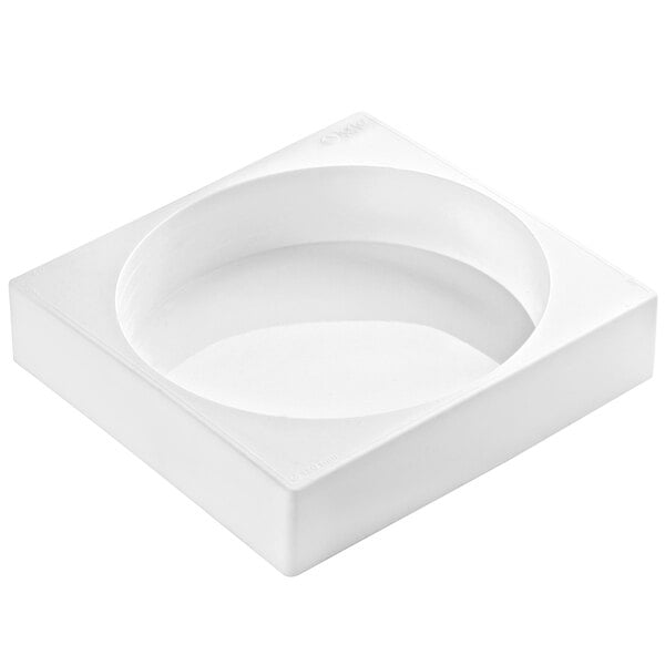 A white square silicone baking mold with a round center.