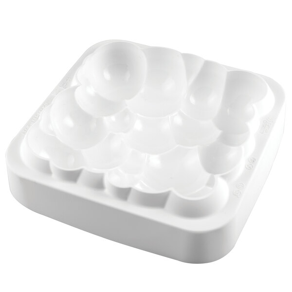A white silicone mold with square bowl-shaped cavities.