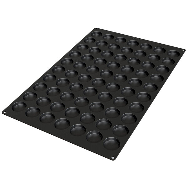 A black Silikomart baking mold with 70 small square cavities.
