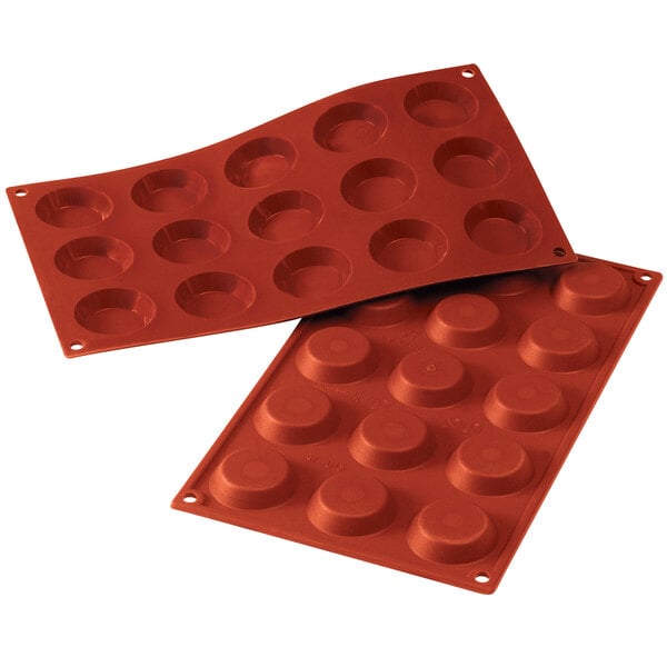 A red Silikomart silicone baking mold with 15 tartelette cavities.