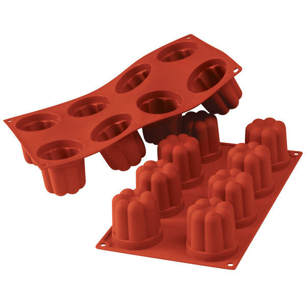 A close up of a red Silikomart silicone baking mold with 8 compartments.