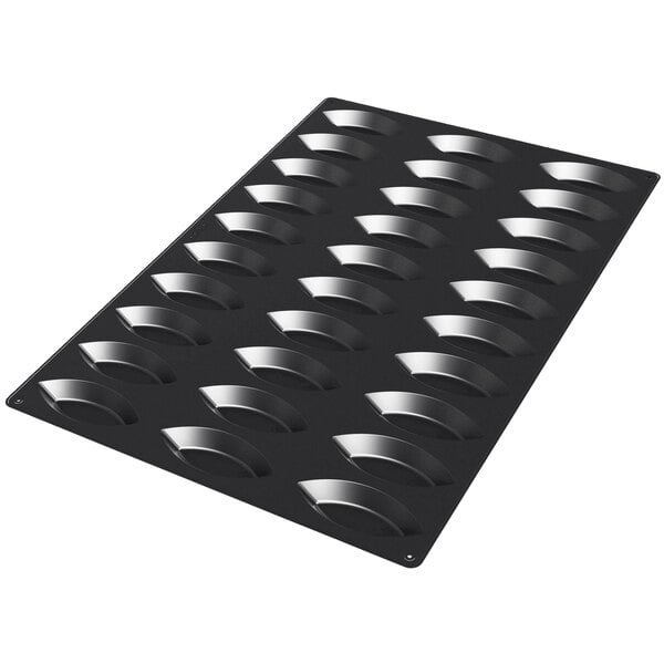 A black Silikomart silicone baking mold with 30 boat-shaped cavities.
