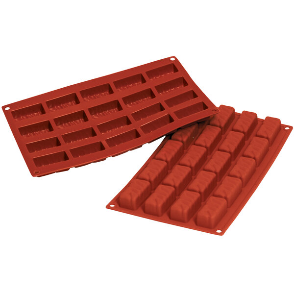 A close-up of a red Silikomart silicone baking mold with 20 rectangular cavities.