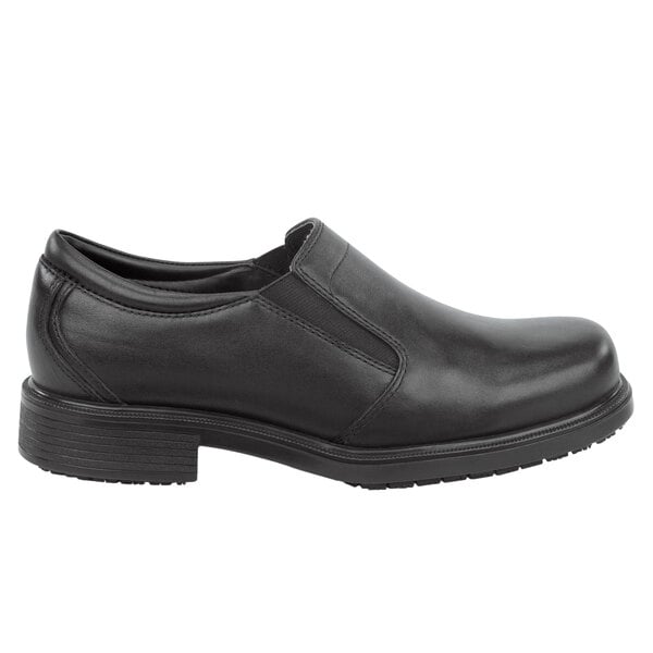 A black Rockport Works men's slip-on dress shoe with a rubber sole.
