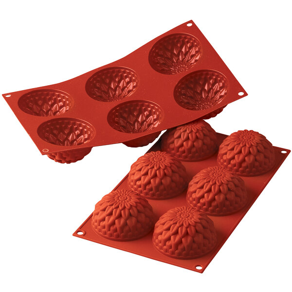 A red Silikomart silicone baking mold with six dahlia-shaped cavities.