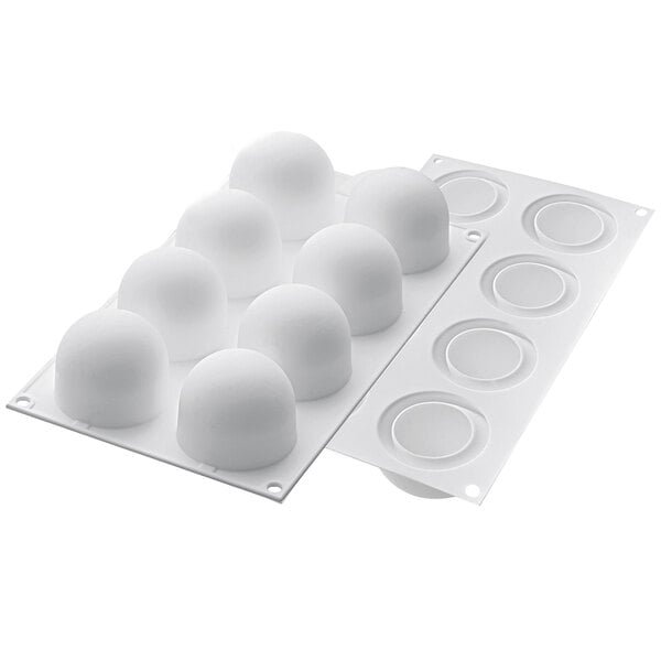 A white plastic mold with round objects.