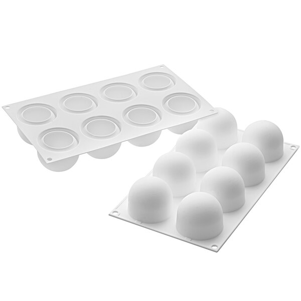 A white silicone baking mold with round cavities each with a black border.