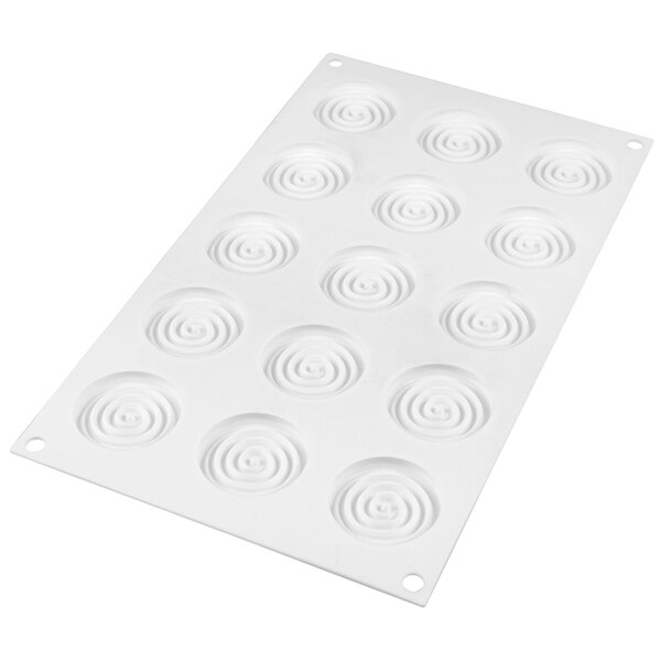 A white Silikomart silicone mold with circular spiral cavities.