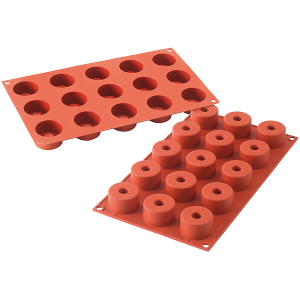 A red silicone baking mold with circle-shaped cavities.
