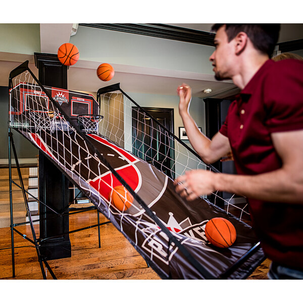 A man playing Triumph Playmaker Double Shootout basketball.