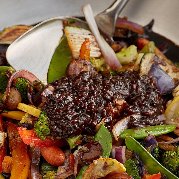 A pan of food with Lee Kum Kee Black Bean Garlic Sauce and vegetables.