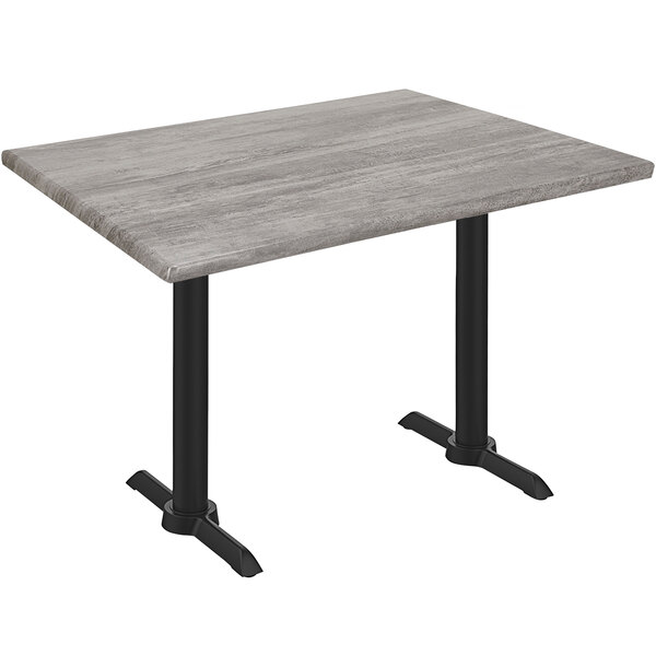 A Holland Bar Stool EnduroTop table with a Greystone wood laminate top and black end column base.