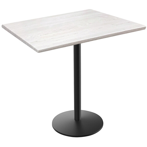 A white table with a black round base and pole.