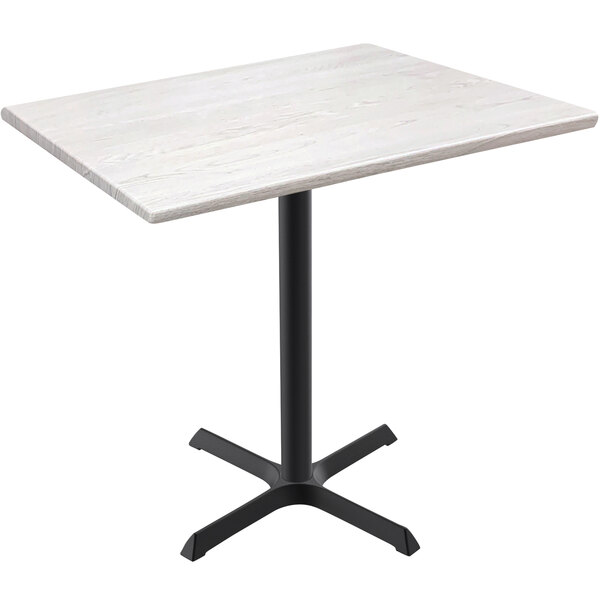 A white table with a white ash wood cross base.