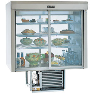 A Delfield countertop refrigerated display case with food on shelves.