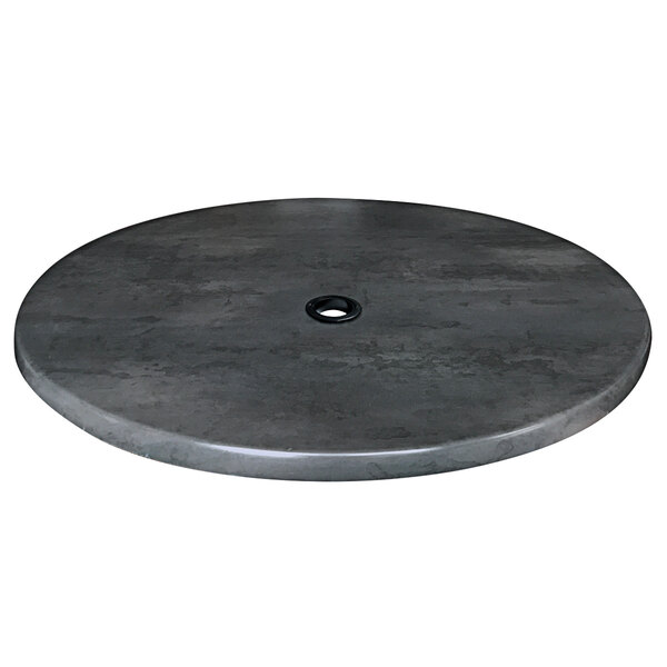 A round black steel laminate table top with a hole in the middle.