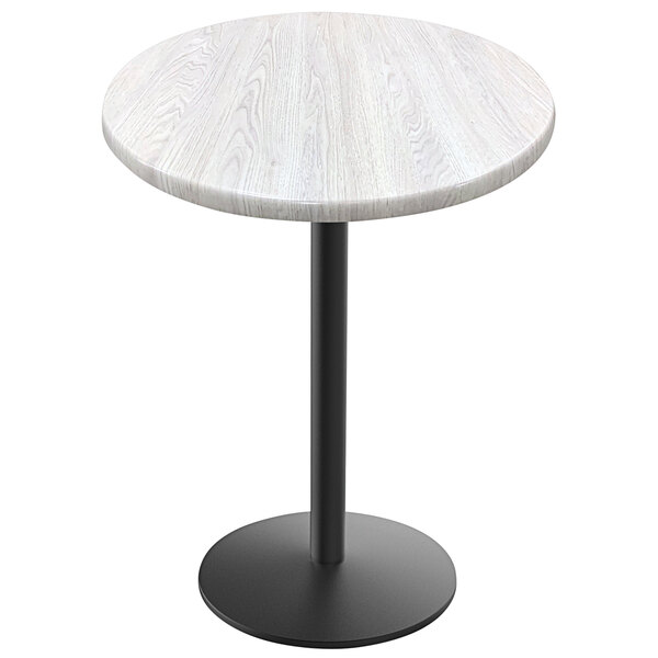 A white round table top with a black round base.