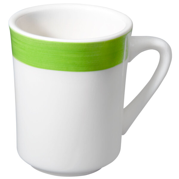 A close-up of a white coffee mug with a green stripe and handle.