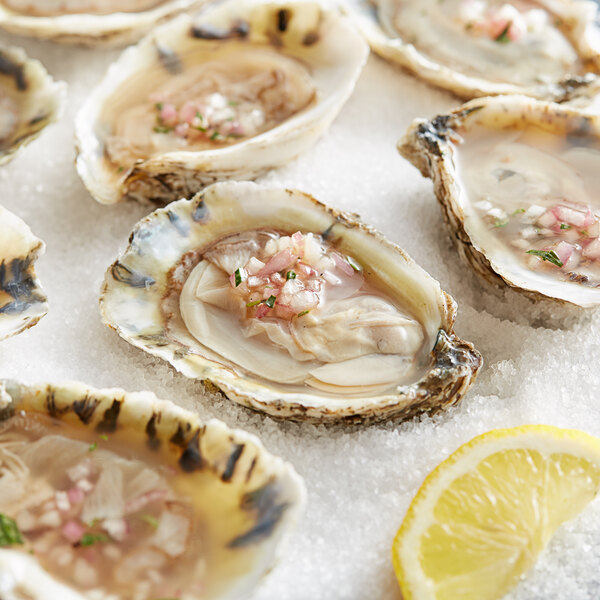 A plate of Rappahannock River Oysters with lemon slices.