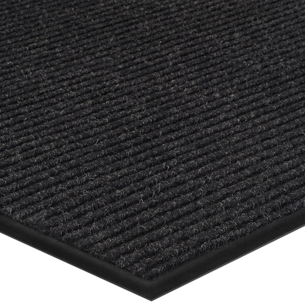 A close up of a black Lavex Needle Rib entrance mat with a black stripe.