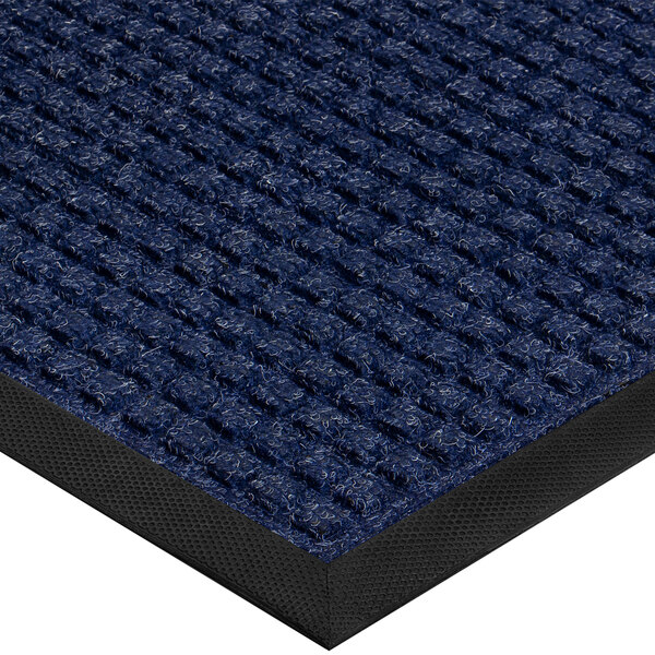 A close up of a blue Lavex waffle indoor entrance mat with a black border.