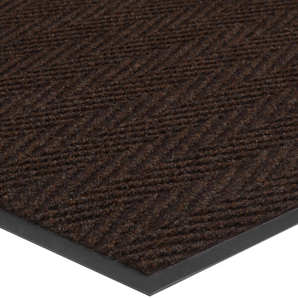A close-up of a black and brown Chevron patterned carpet.