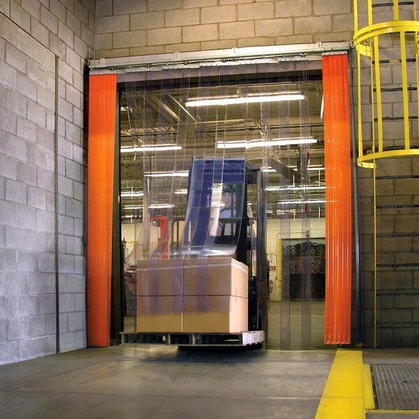 A yellow forklift driving through a large PVC strip door in a warehouse.