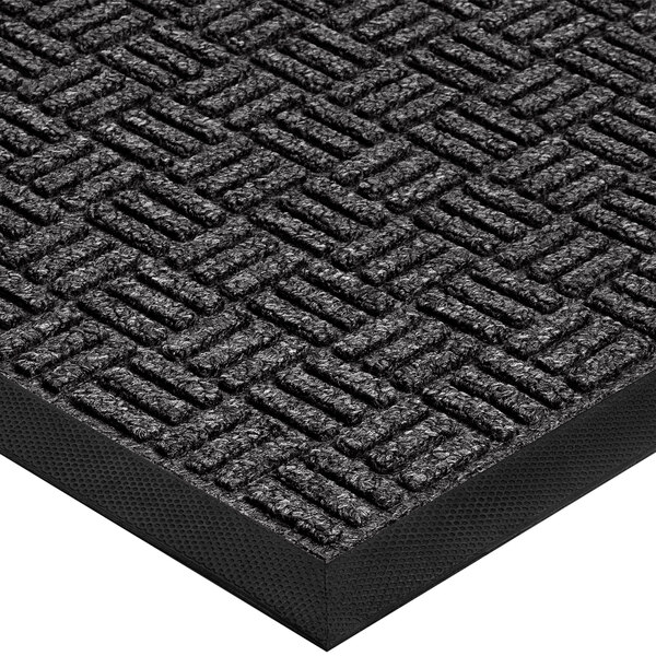 A close-up of a black rubber Lavex entrance mat with a pattern on it.