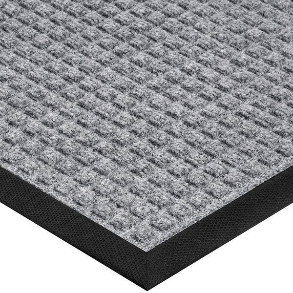 A gray Lavex waffle entrance mat with a black border.