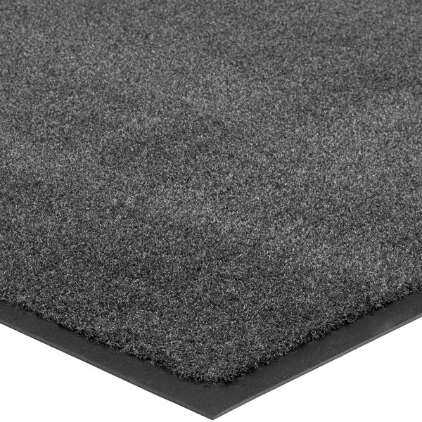 A close up of a Lavex charcoal gray carpet mat with black edges.