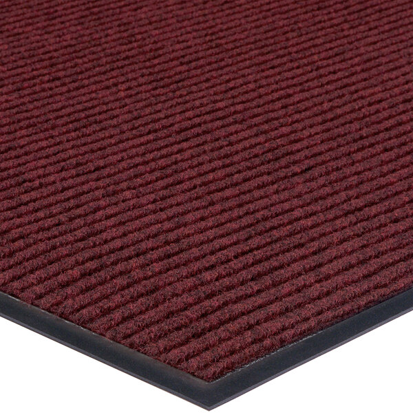 A red Lavex Needle Rib carpet mat with black borders.