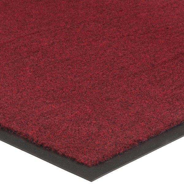 A close up of a red Lavex Olefin entrance mat with black border.