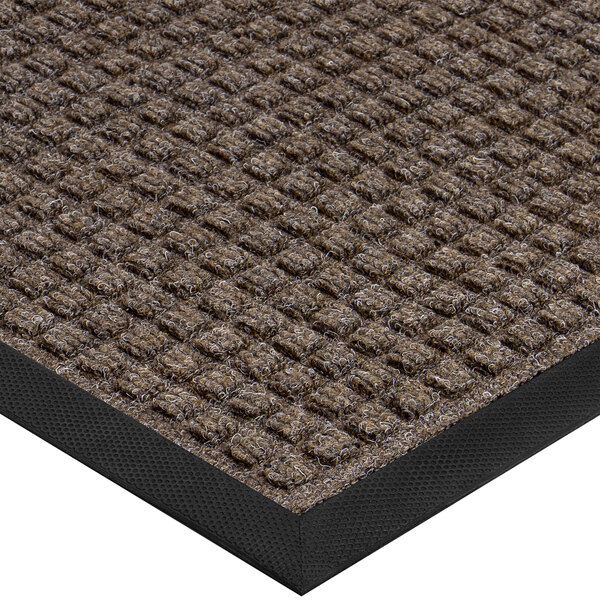 A white indoor entrance mat with a brown waffle pattern and black border.