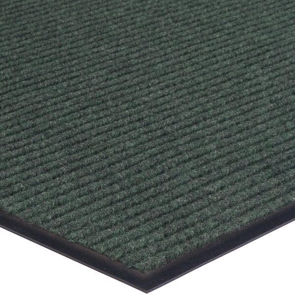 A close up of a green Lavex carpet mat with black trim.