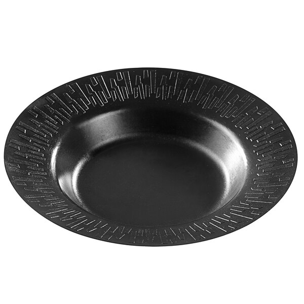 A black round Solia sugarcane plate with a design on it.